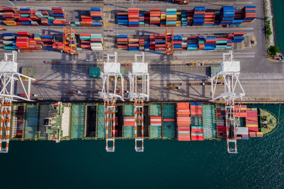 containers ship and ports freight load unloading by crane forwarding industry import export international worldwide business services transportation of goods in ocean waters Asia Pacific and Europe 
